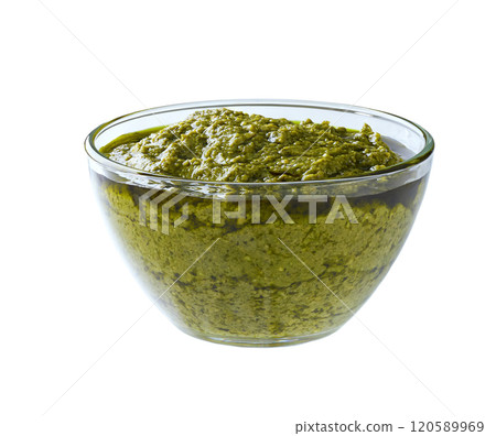 Pesto sauce in a clear glass bowl isolated on white background. 120589969