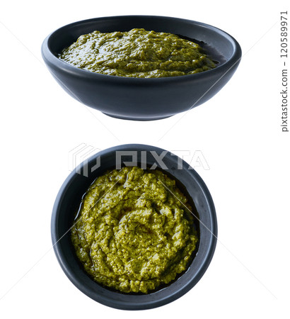 sauce pesto in a black ceramic bowl isolated on white background. 120589971