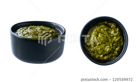 sauce pesto in a black ceramic bowl isolated on white background. 120589972