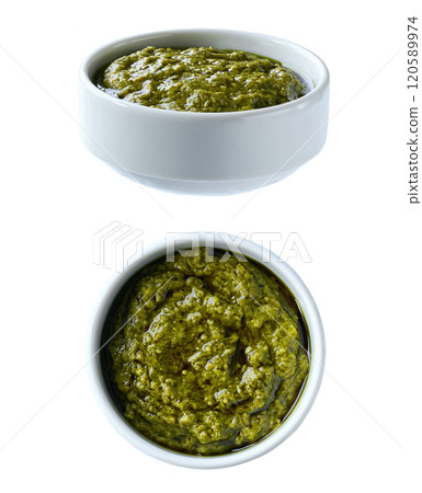 Traditional italian sauce pesto in a ceramic bowl isolated on white background. Traditional italian sauce pesto in a ceramic bowl isolated on white background. 120589974