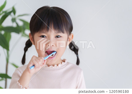 Child brushing teeth with a toothbrush Child brushing teeth with a toothbrush 120590180