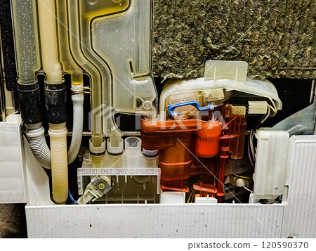 Side view of the dishwasher without the top panel. Working system for pumping and draining water into the device. After renovation. 120590370