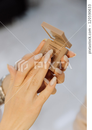 Applying glittery eyeshadow with precision for a flawless makeup finish 120590633