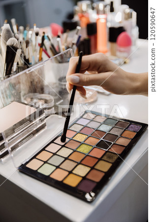 Vibrant eyeshadow palette with makeup brush creating stunning beauty looks at a professional station 120590647