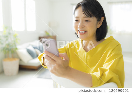 A woman watching a smartphone A woman watching a smartphone 120590901