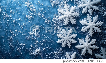 Frozen snowflakes scattered on a blue background create a winter wonderland effect with texture 120591336
