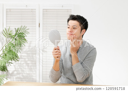 A man with a hand mirror 120591718
