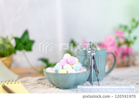 A pile of Ramune and a compass leaning against a coffee cup 120591970