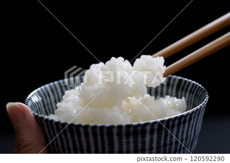 Eating rice, holding a rice bowl, close-up of hands 120592290