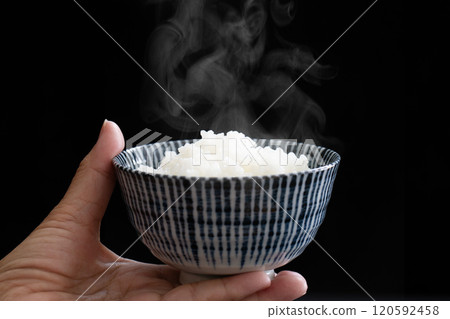Close-up of a woman's hands holding rice 120592458