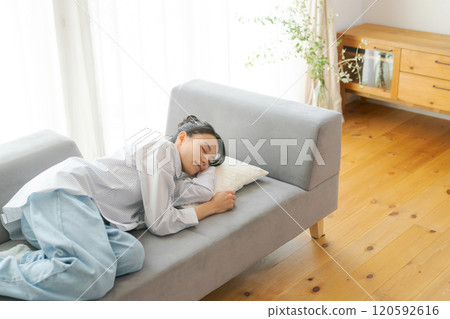 A woman taking a nap on the sofa A woman taking a nap on the sofa 120592616