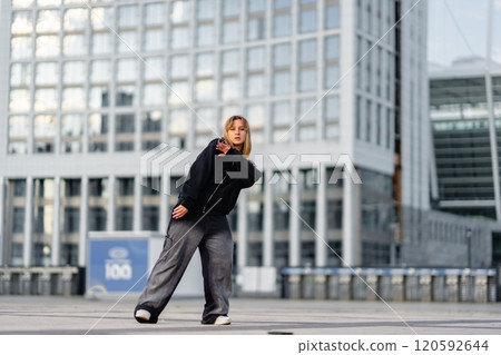 Young dancer performing in urban area during daytime 120592644
