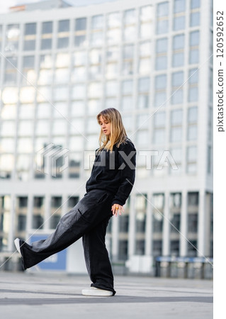 Young woman showcases her dance moves in an urban environment Young woman showcases her dance moves in an urban environment 120592652
