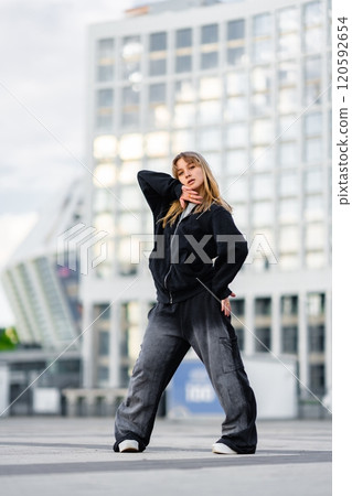 Dancer performs stylish routine in urban setting during afternoon Dancer performs stylish routine in urban setting during afternoon 120592654