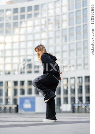 Dance performance of a young woman in urban setting during the day 120592696