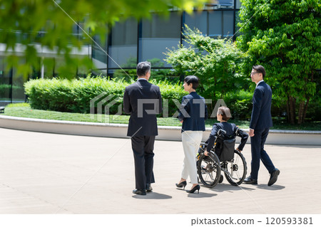 Business wheelchair team walking back view Business wheelchair team walking back view 120593381