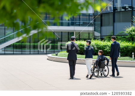 Business wheelchair team walking back view Business wheelchair team walking back view 120593382