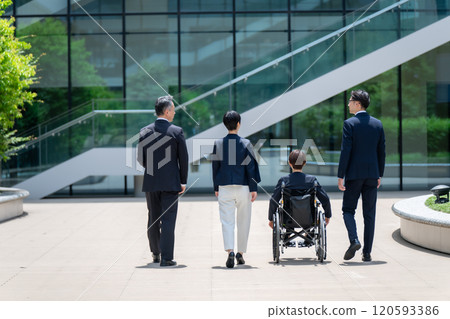 Business wheelchair team walking back view 120593386