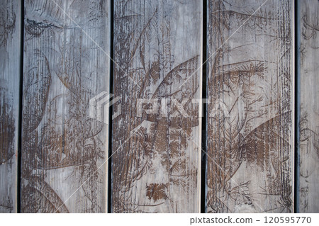 Close-Up of Weathered Wooden Planks With Leaf Patterns Close-Up of Weathered Wooden Planks With Leaf Patterns 120595770