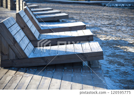 Wooden Loungers on Frosty Beach Boardwalk in Winter Morning Wooden Loungers on Frosty Beach Boardwalk in Winter Morning 120595775