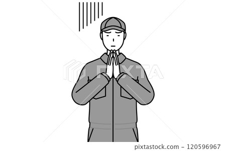 一名身穿連身褲的機械師雙手合十在身前道歉 一名身穿連身褲的機械師雙手合十在身前道歉 120596967