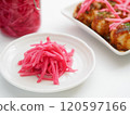 Pickled ginger and takoyaki served on a plate 120597166