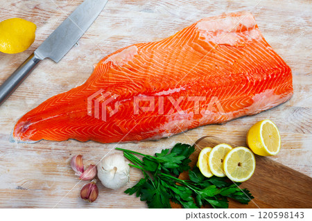Raw red fish salmon fillet, lemon, parsley 120598143