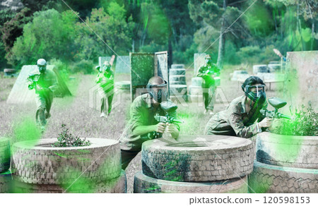 Two active opposing teams with guns playing paintball Two active opposing teams with guns playing paintball 120598153