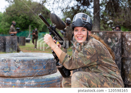 Portrait of girl in camouflage on paintball field Portrait of girl in camouflage on paintball field 120598165