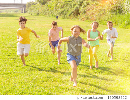 Barefoot kids running on green grass 120598222