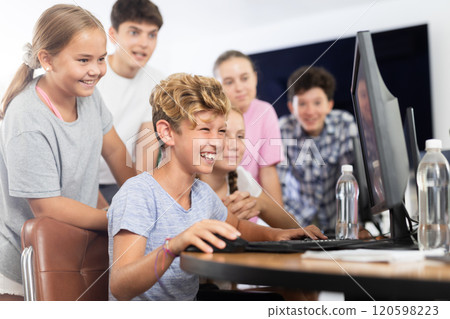 Classmates solve computer problem together in school computer class Classmates solve computer problem together in school computer class 120598223