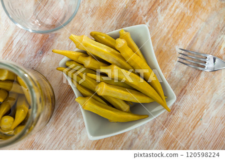 Marinated okra pods served on plate Marinated okra pods served on plate 120598224