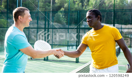 Men handshaking after padel tennis match outdoors Men handshaking after padel tennis match outdoors 120598249