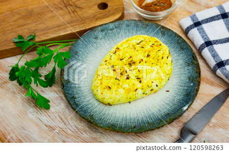 Traditional lithuanian farm cheese on plate with herbs and spices. Keptas varskes suris su ciberzole 120598263