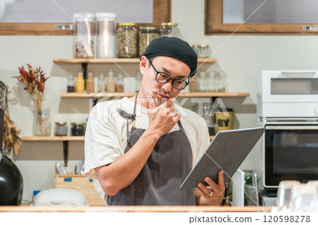 Restaurant staff checking orders on tablet Restaurant staff checking orders on tablet 120598278