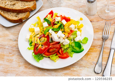 Salad with cheese, tomato, peppers, and corn 120598285