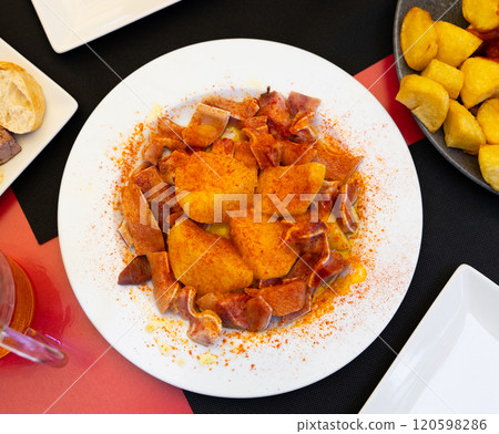 Pieces of pickled and boiled pork ears perfectly complement glass of dark beer. 120598286