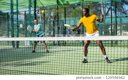 African american man padel tennis player trains on the court African american man padel tennis player trains on the court 120598362