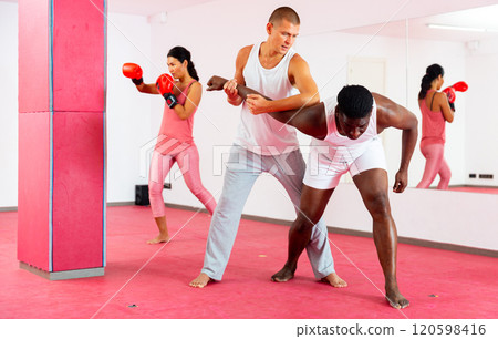 Sparring of two men at self-defense training in sports club 120598416