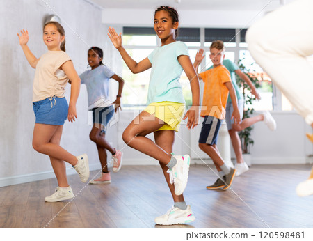 Smiling african american tween girl learning dynamic dances in choreography class Smiling african american tween girl learning dynamic dances in choreography class 120598481