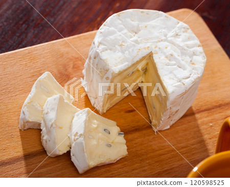 Tasty slices of french cambozola cheese at wooden desk 120598525