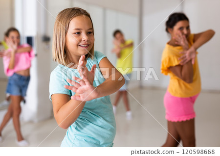 Young girls and boys performing modern dance in studio 120598668