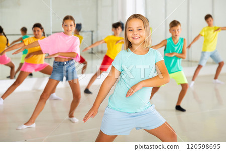 Children exercising modern dance moves together Children exercising modern dance moves together 120598695