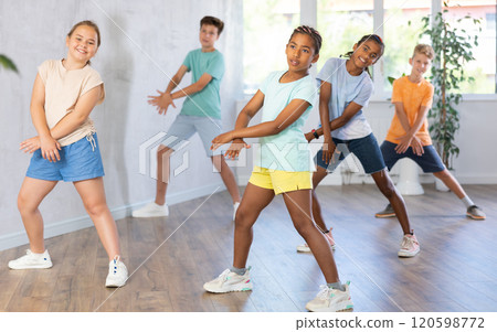 Dance studio - smiling girls and boys in dance lesson Dance studio - smiling girls and boys in dance lesson 120598772