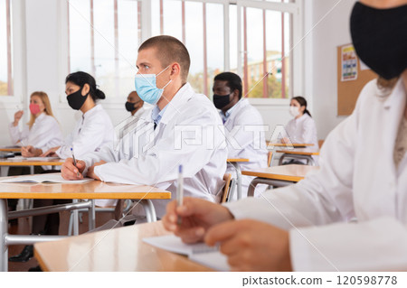 Group of medical academy students in protective masks at lesson Group of medical academy students in protective masks at lesson 120598778