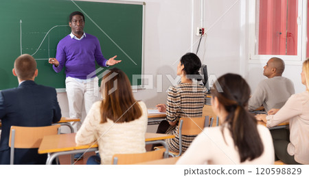 African American teacher giving lesson to group of adult students African American teacher giving lesson to group of adult students 120598829