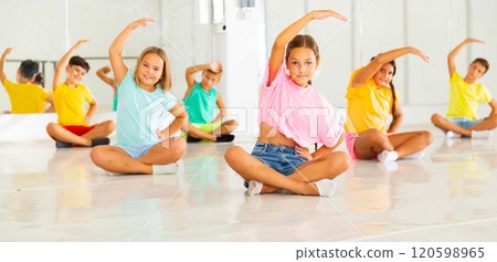 Young boys and girls sitting and training ballet moves Young boys and girls sitting and training ballet moves 120598965