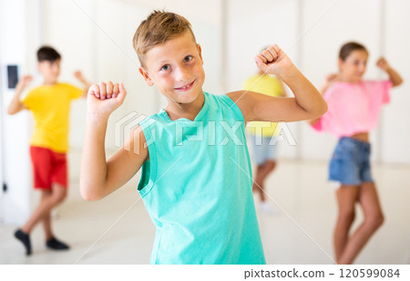 Young girls and boys performing dance in studio 120599084