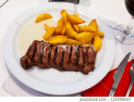 Tasty beef steak with baked potatoes and roquefort 120599097