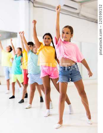 Boys and girls standing in row in dance room 120599152